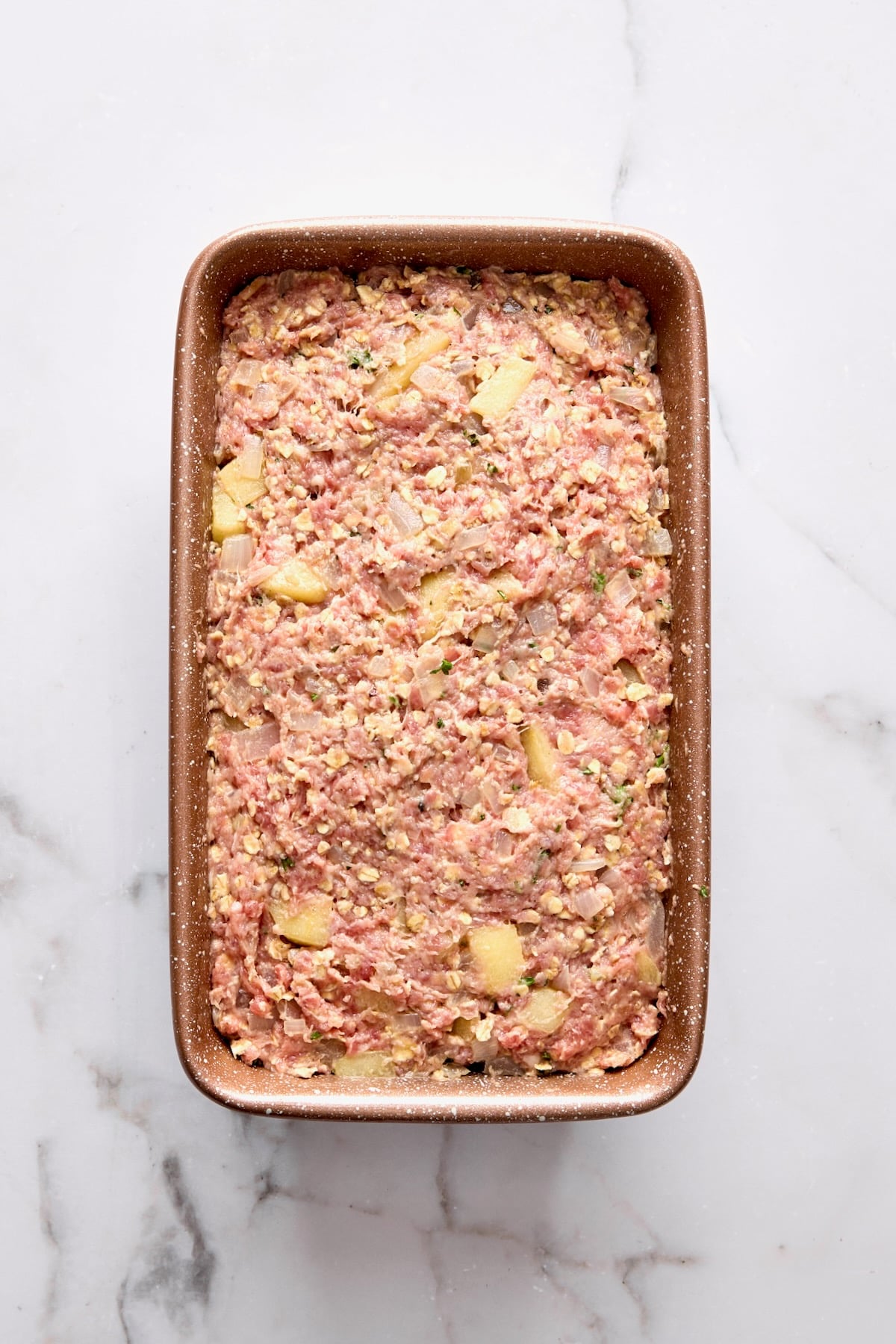 Turkey meatloaf in brown loaf pan.
