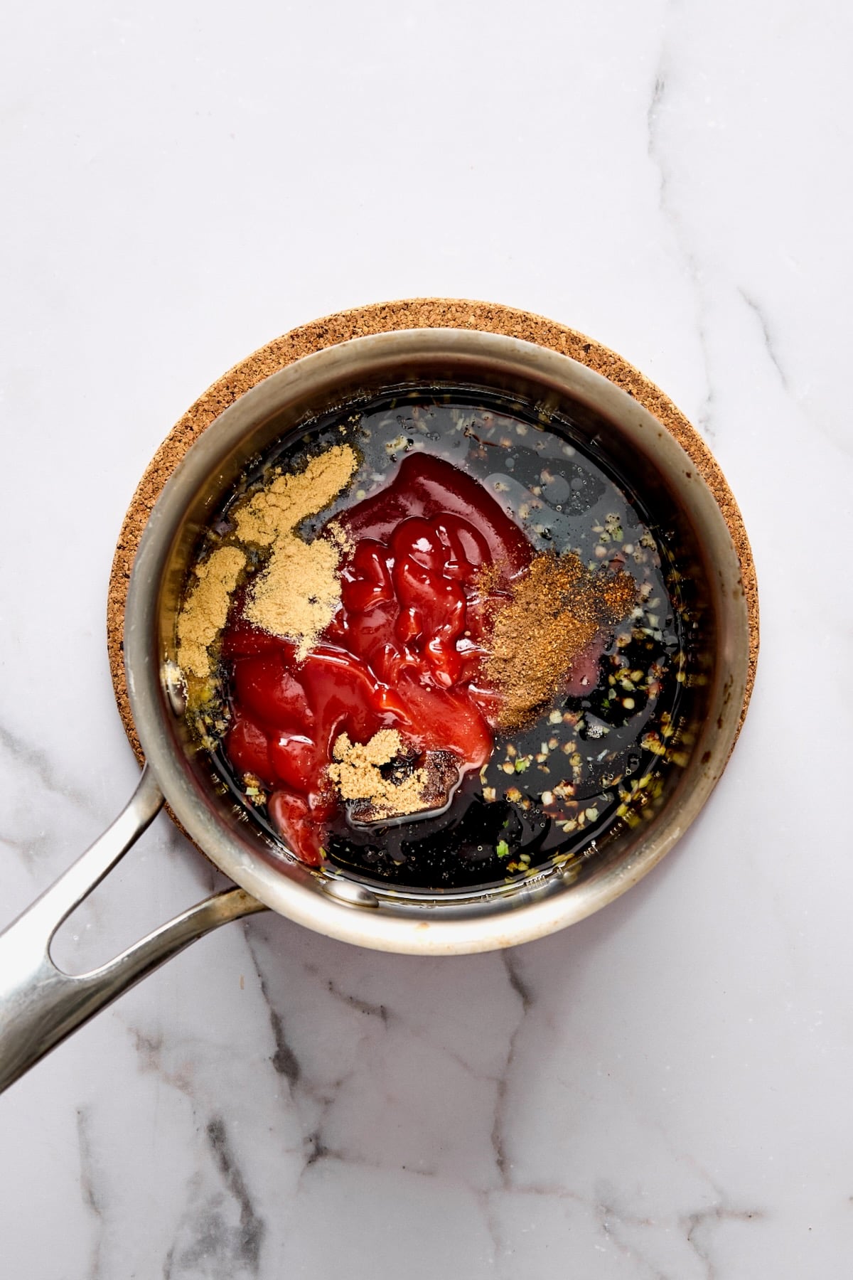 Glaze ingredients in stainless steel saucepan before being mixed together and cooked.