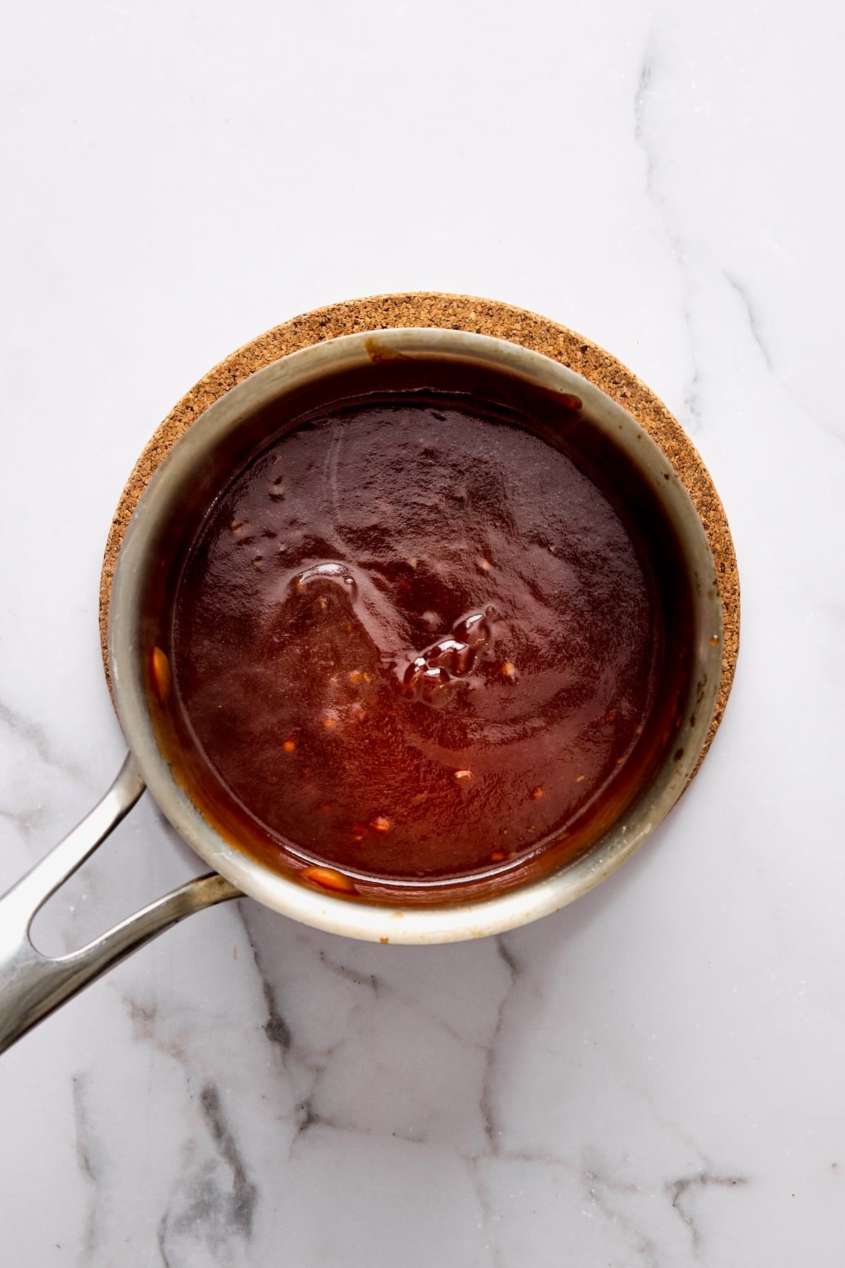 Balsamic Ketchup Glaze in stainless steel saucepan.