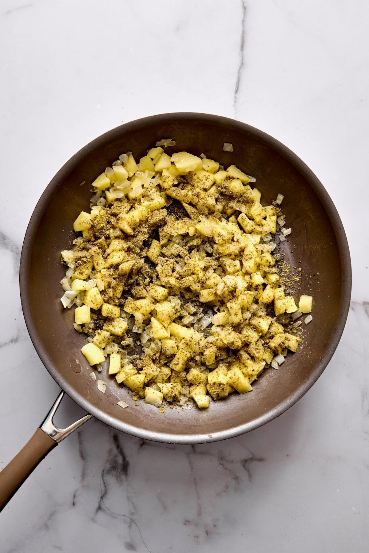 Cooked onions, apple and sage in nonstick skillet.