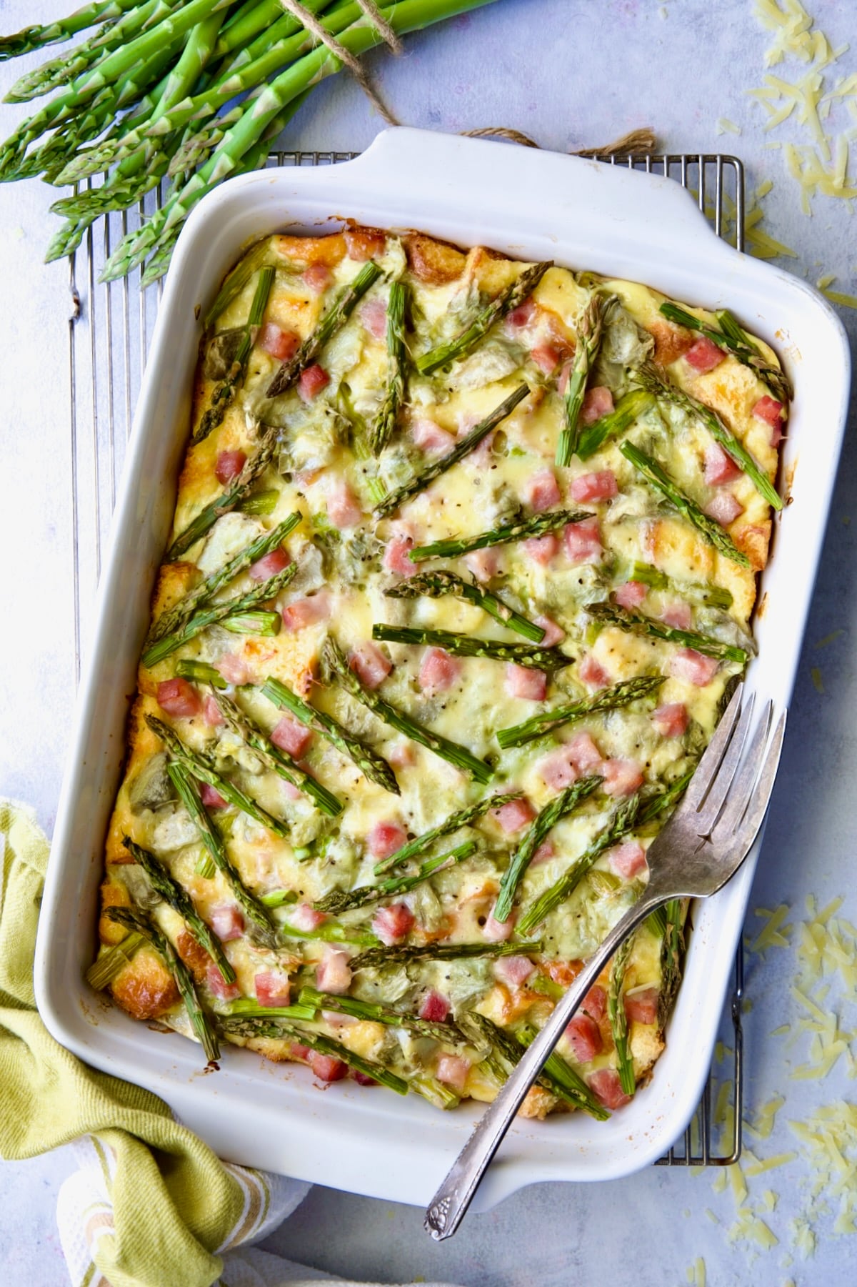Baked Brioche Breakfast Strata on cooling rack with serving fork.