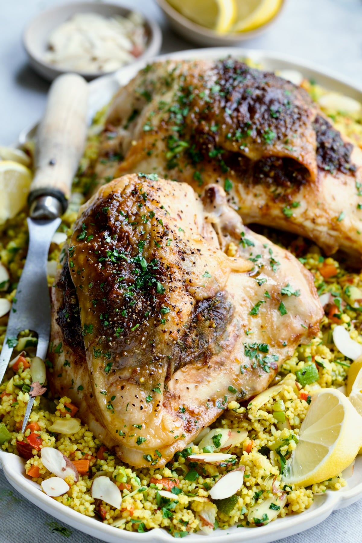 Moroccan Chicken with Jeweled Couscous on oval white platter.
