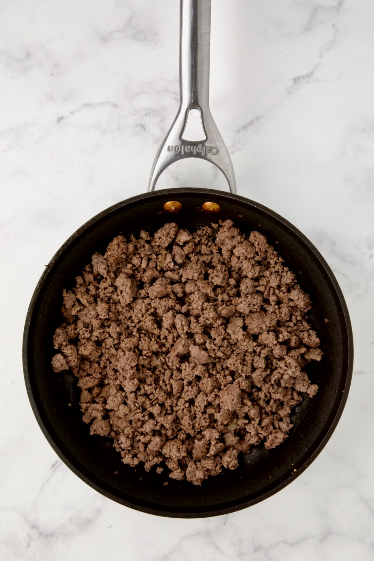 Cooked ground beef in nonstick skillet.