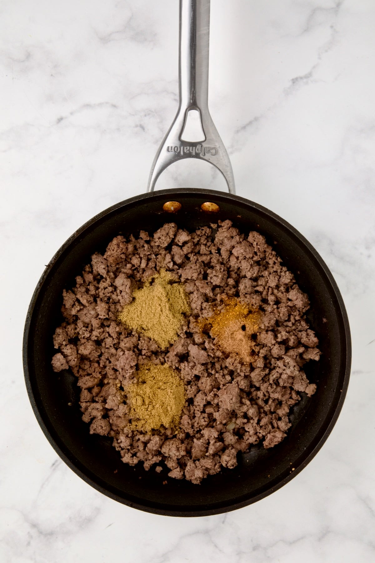 Cooked ground beef in nonstick skillet with coriander, cumin, nutmeg and cayenne added.