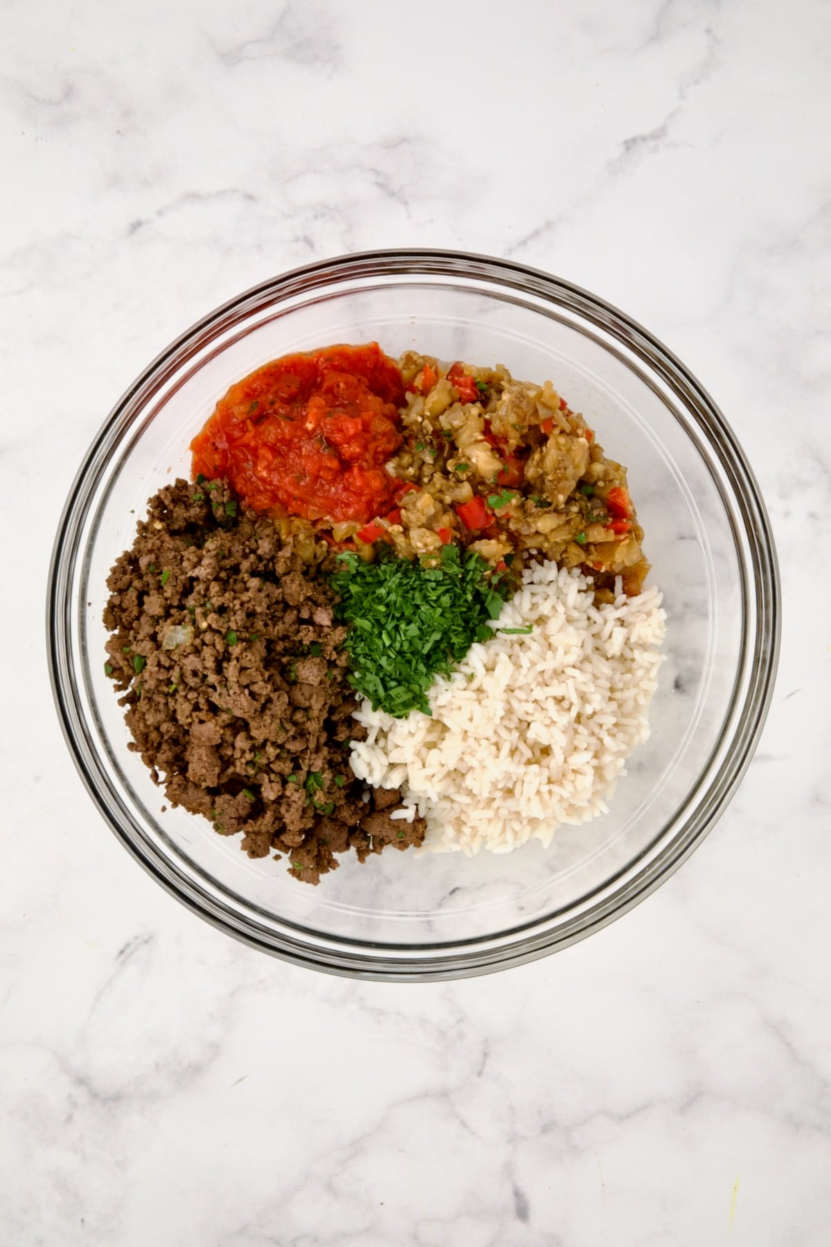 Filling for Stuffed Eggplant in glass bowl before being mixed together.