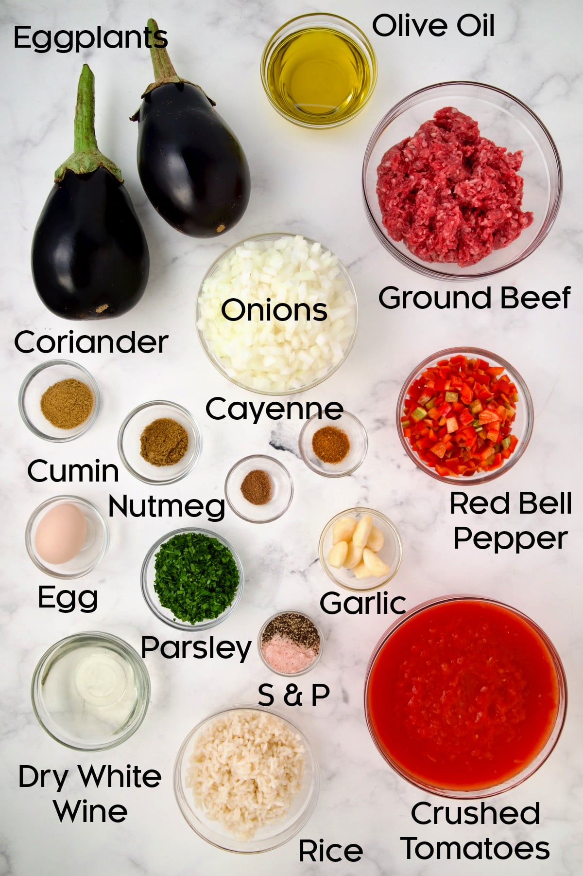 Ingredients for Stuffed Eggplant in glass bowls.