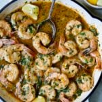 Cajun Butter Shrimp in white enamel cast iron skillet.