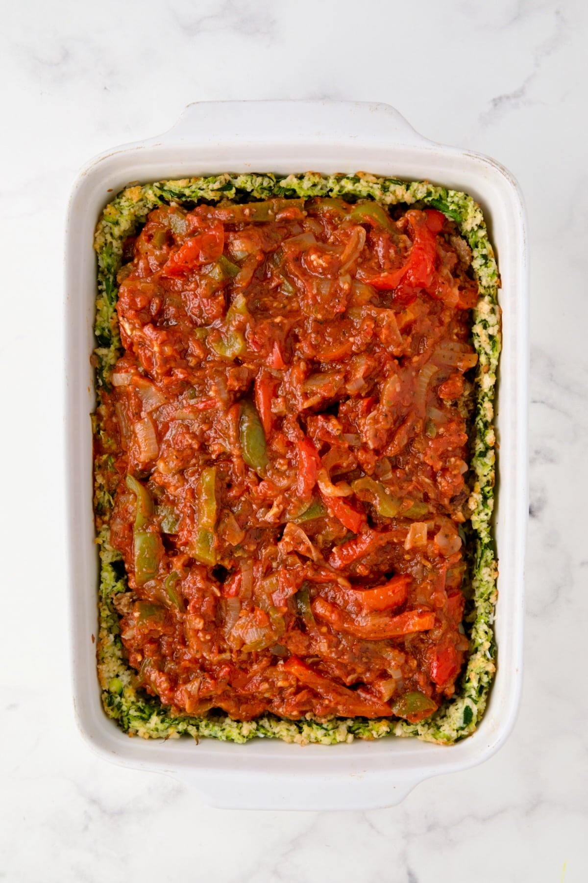 Tomato pepper sauce over sausage.