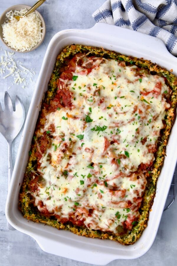 Zucchini Pizza Casserole in white rectangular baking dish before being cut.