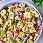 Antipasto Tortellini Salad in serving bowl with serving spoon.