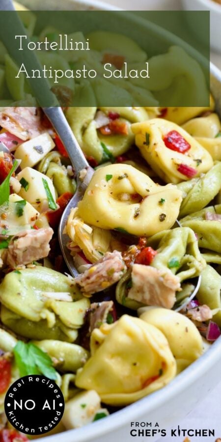 Pinterest graphic for Antipasto Tortellini Salad showing a serving spoon scooping some from a serving bowl.