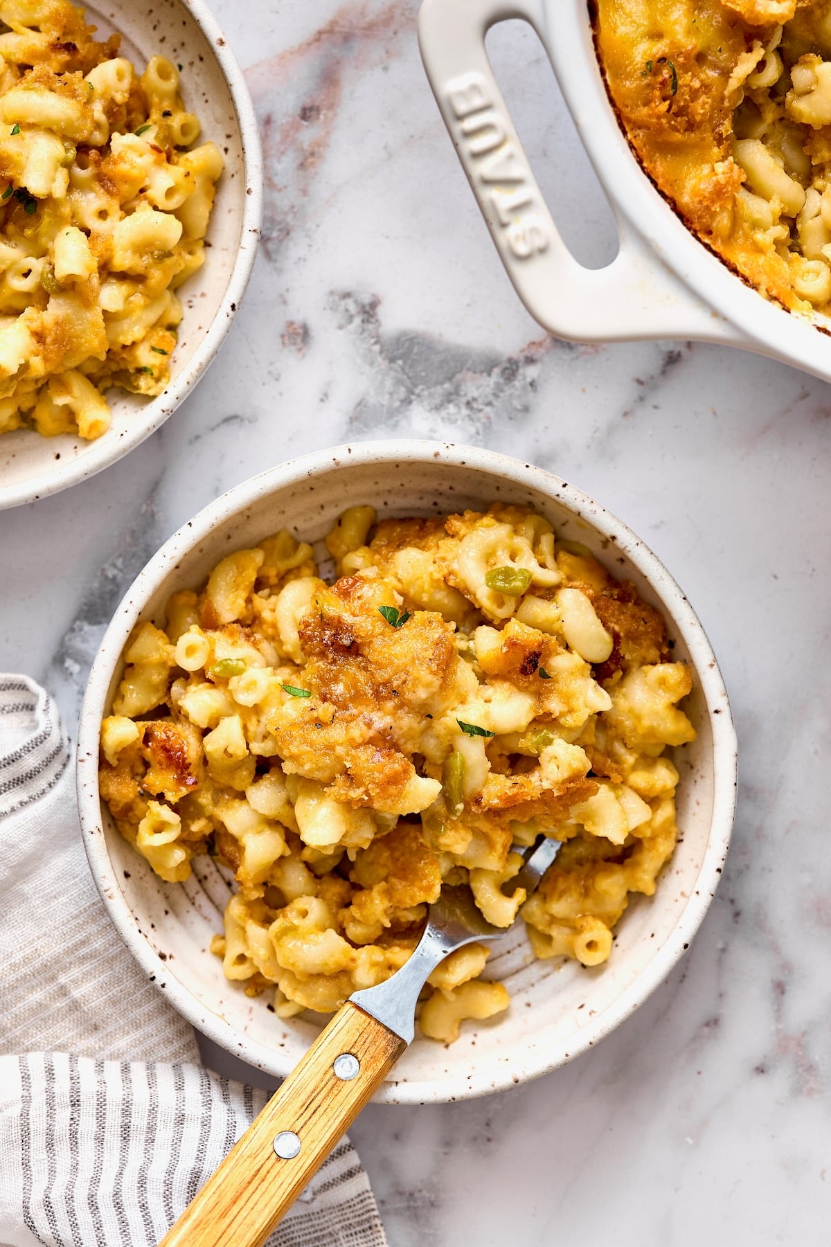 One serving of Hatch Green Chili Mac and Cheese in white bowl with fork.