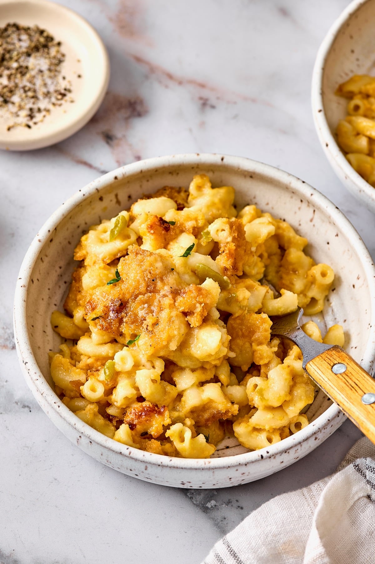 One serving of Hatch Green Chili Mac and Cheese in white bowl with fork.