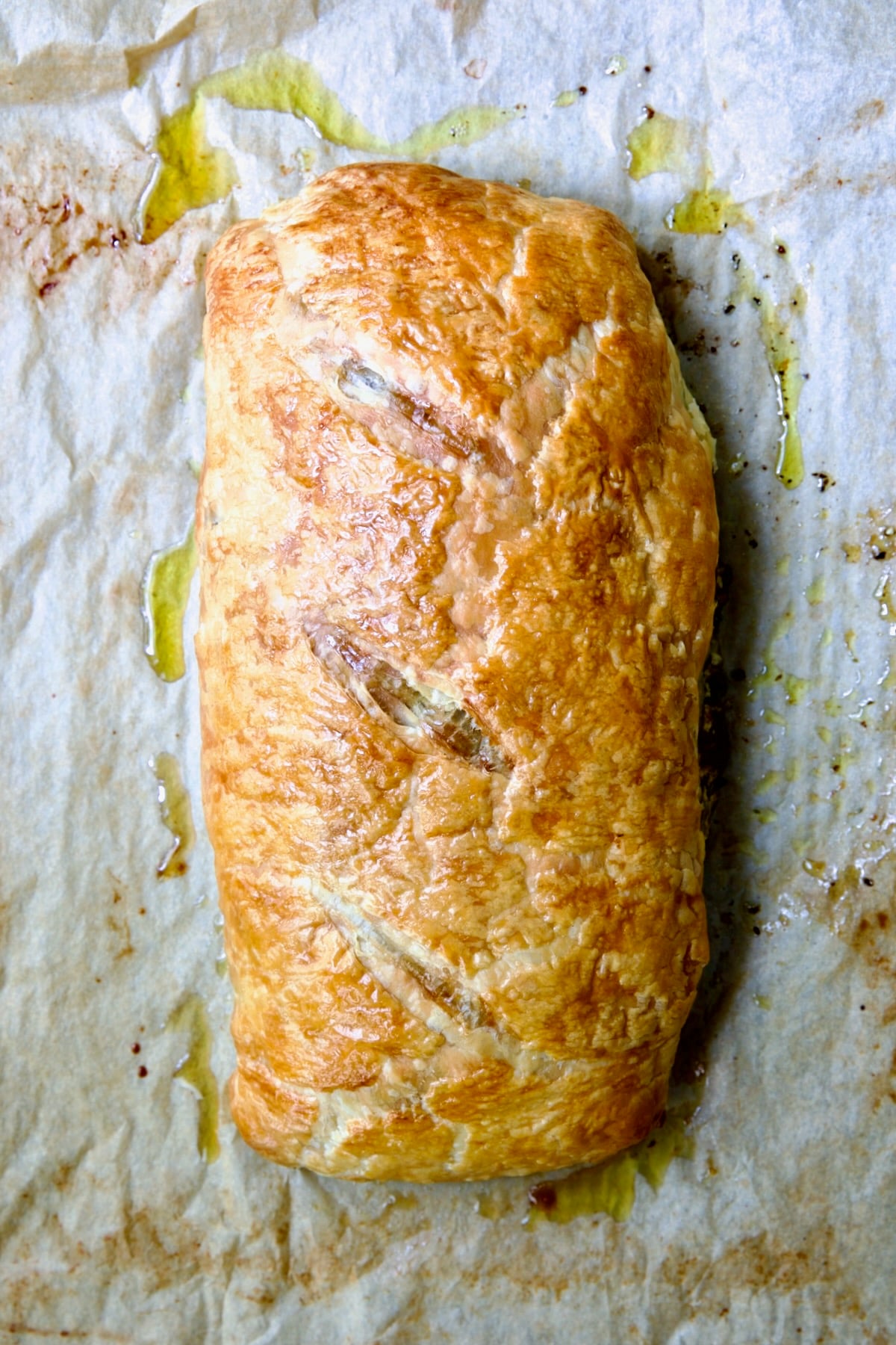 Fully baked Italian Vegetable Strudel on parchment paper.