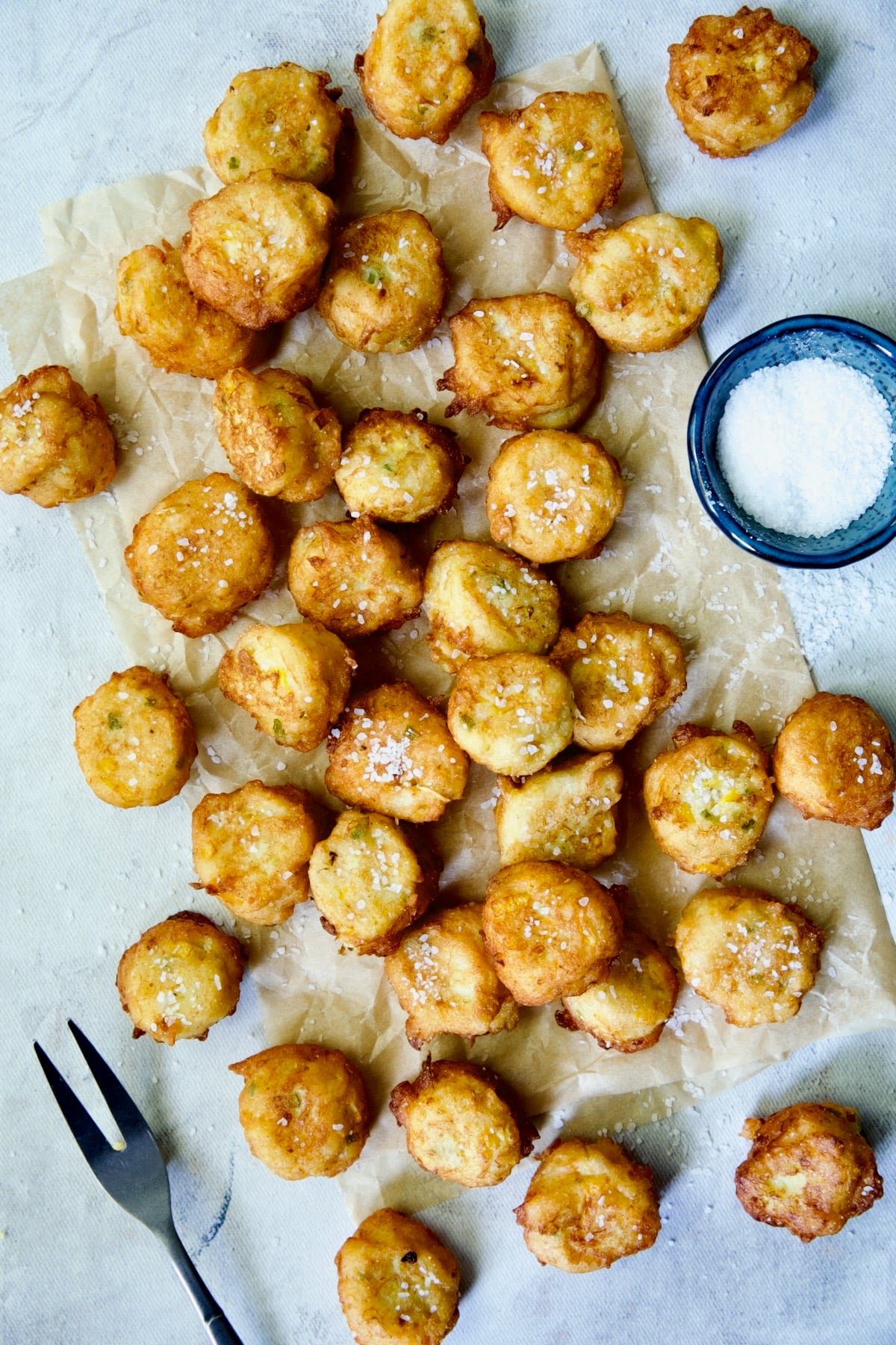 Fried squash puppies on parchment paper.