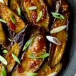 Thai Sweet Chili Eggplant on blue oval plate garnished with scallions.