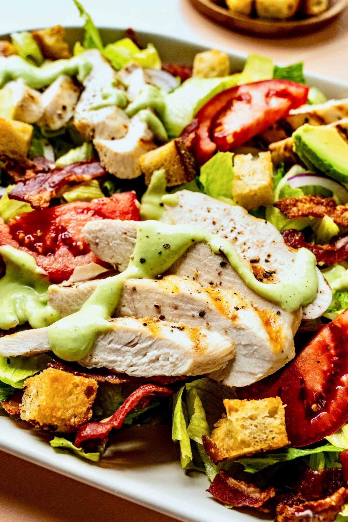 Close-up of Chicken BLT Salad on white platter.