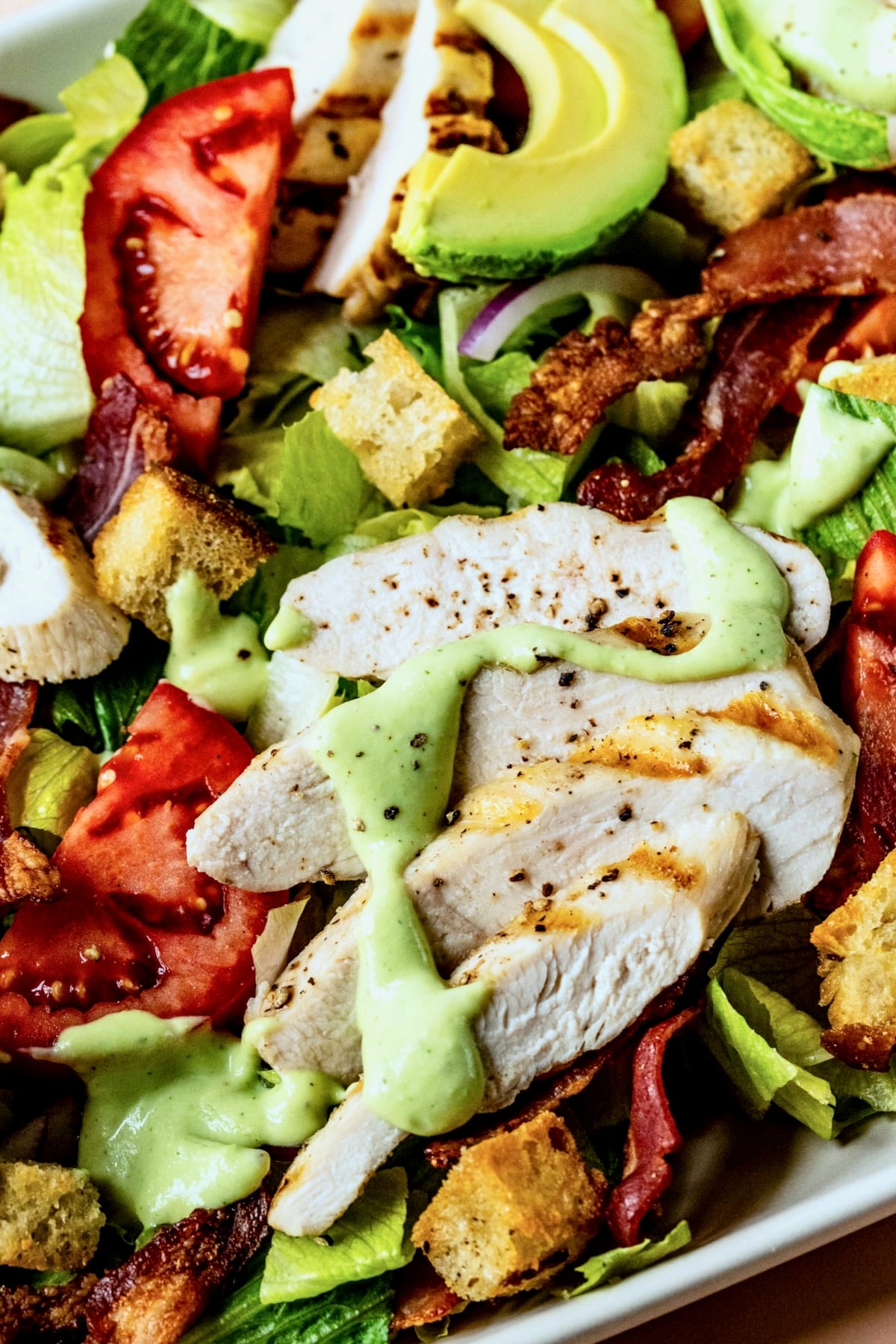 Close-up of Chicken BLT Salad on white platter.