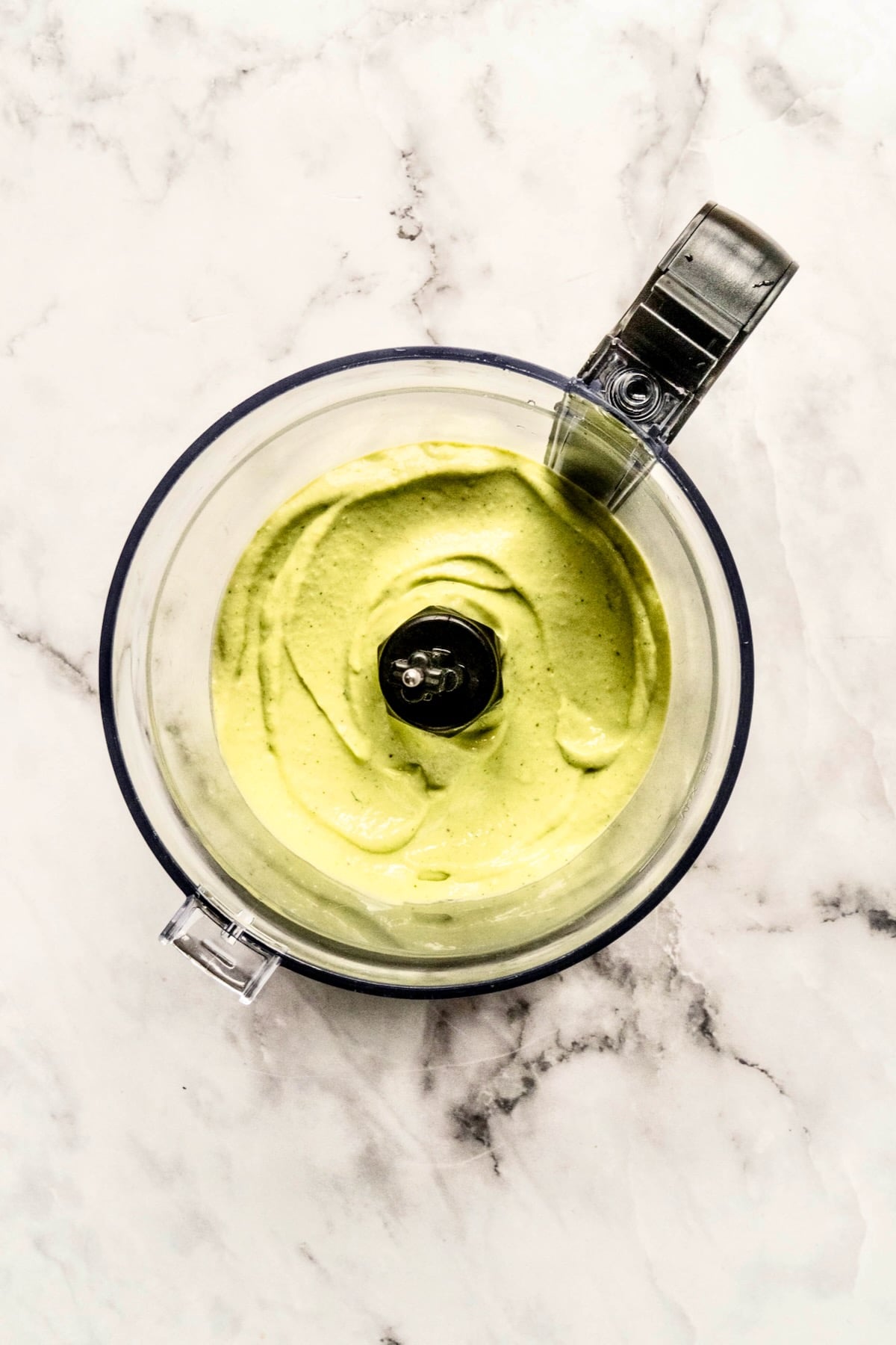Avocado salad dressing in food processor before mayonnaise and buttermilk are added.