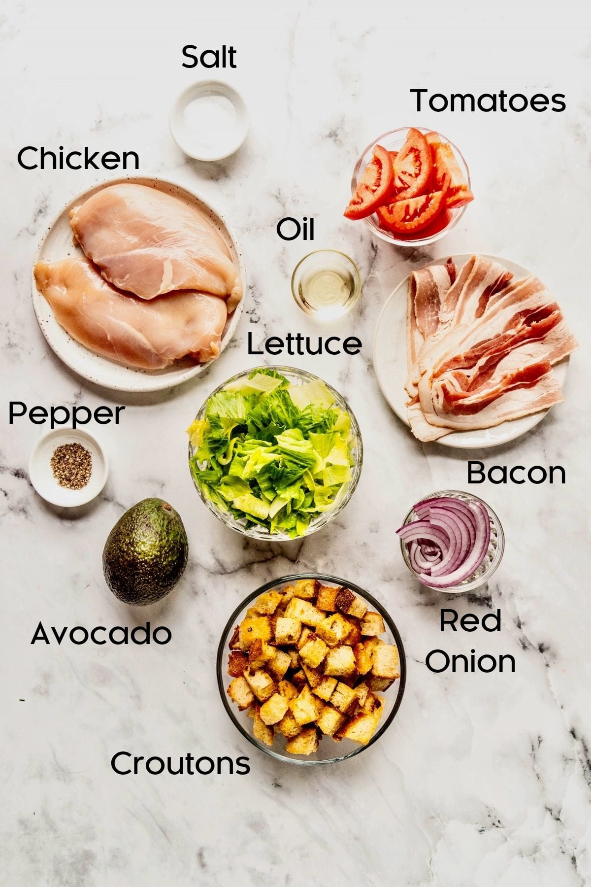 Ingredients for Chicken BLT Salad in bowls and white plates.