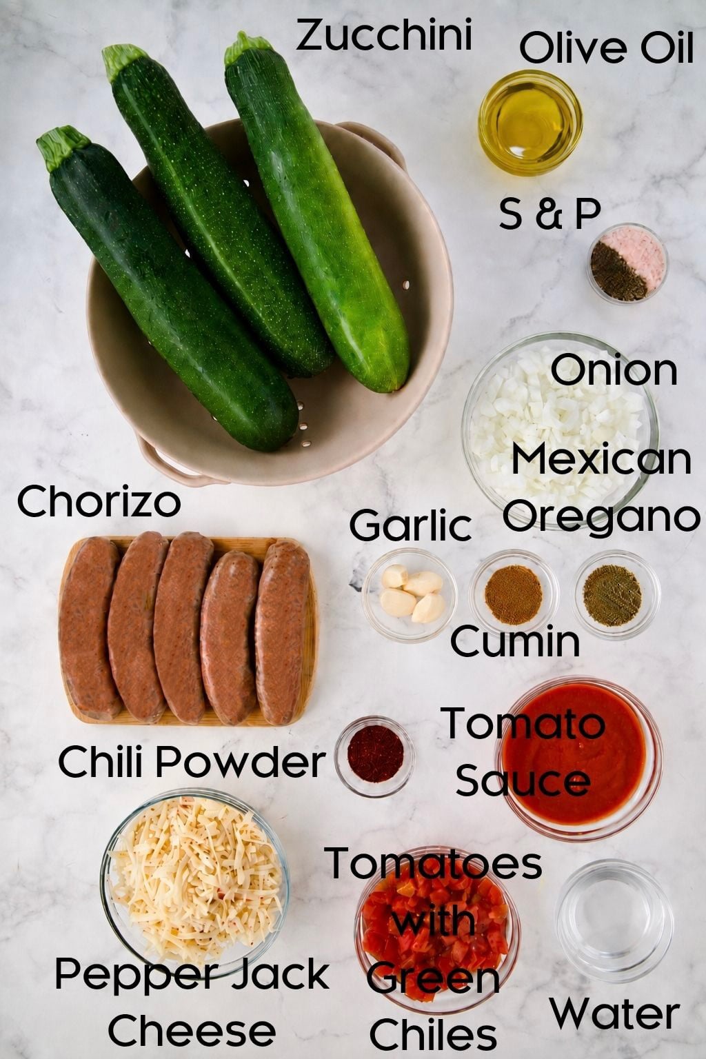 Ingredients for Chorizo-Stuffed Zucchini in glass bowls.