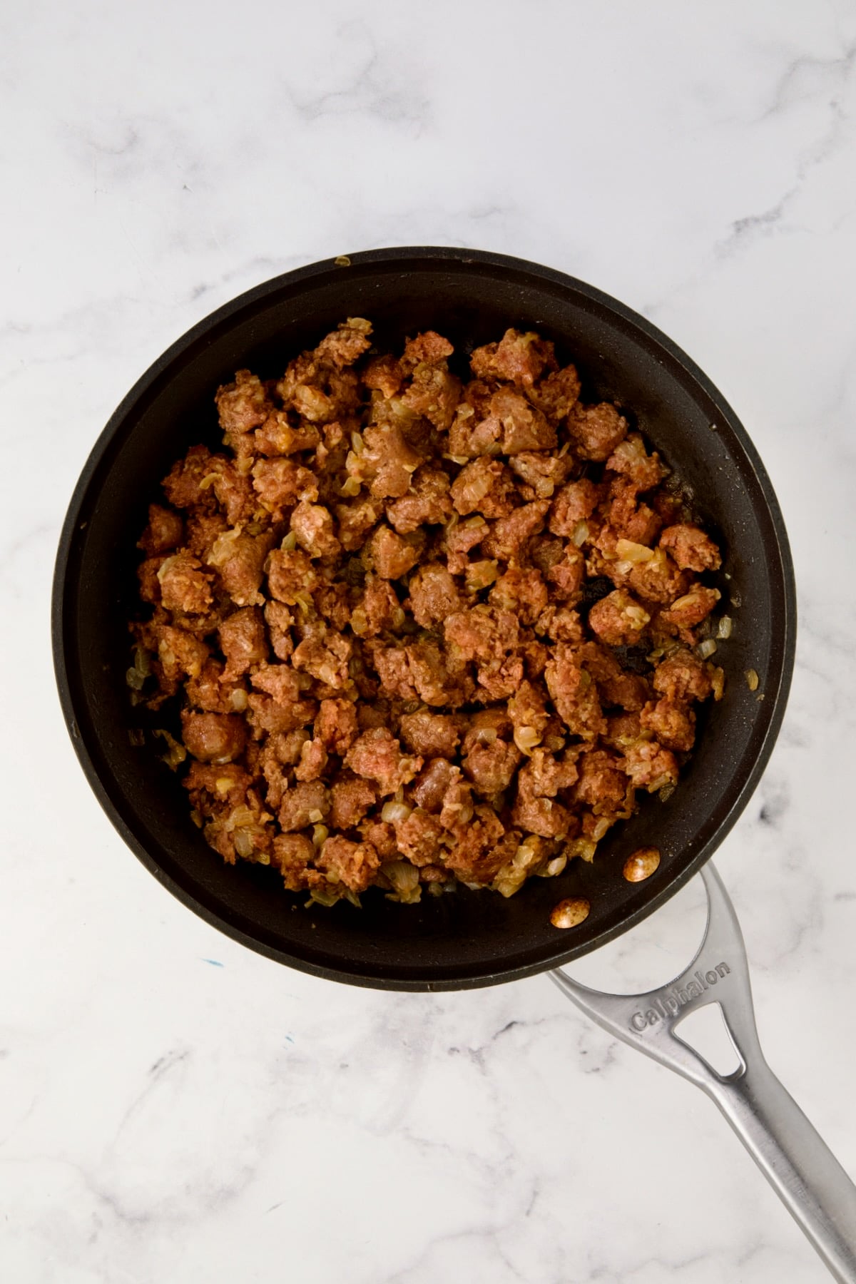 Cooked chorizo and onions in nonstick skillet.