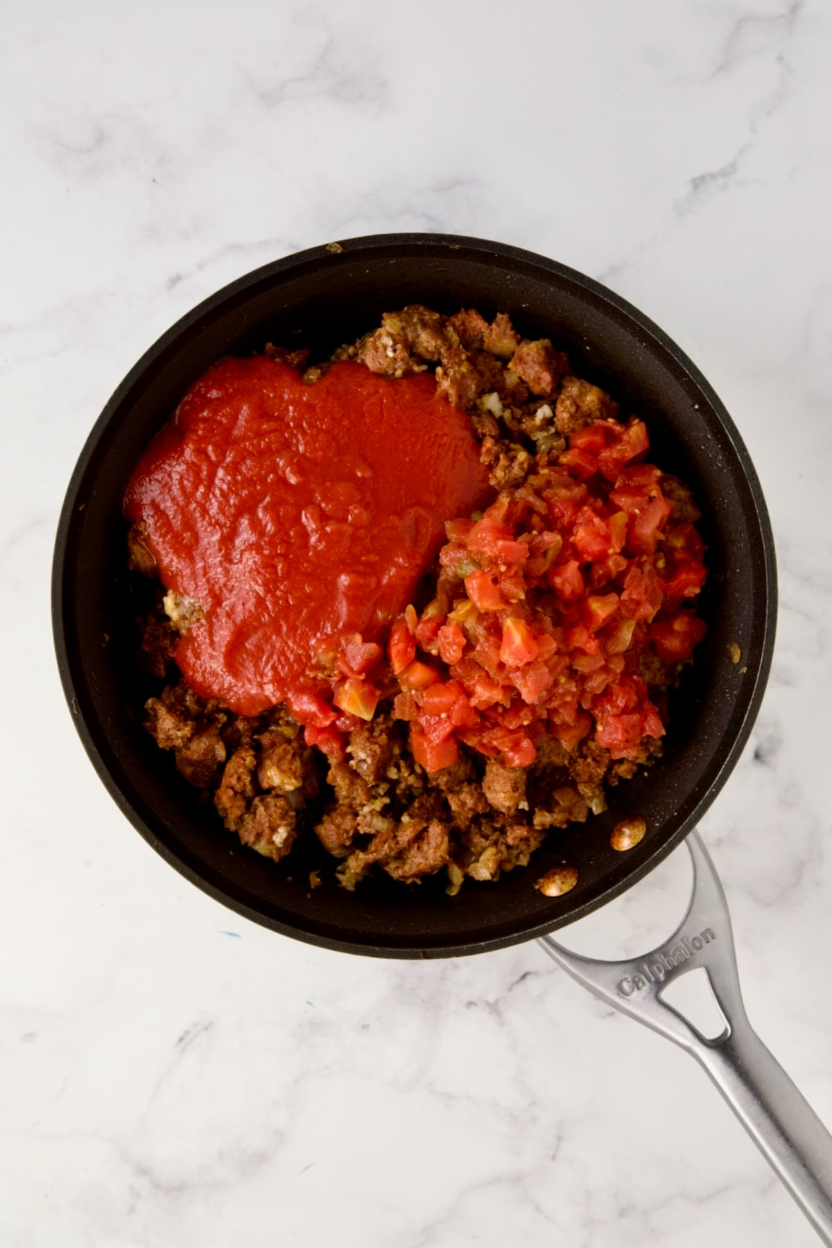 Cooked chorizo with tomato sauce, diced tomatoes and water added.