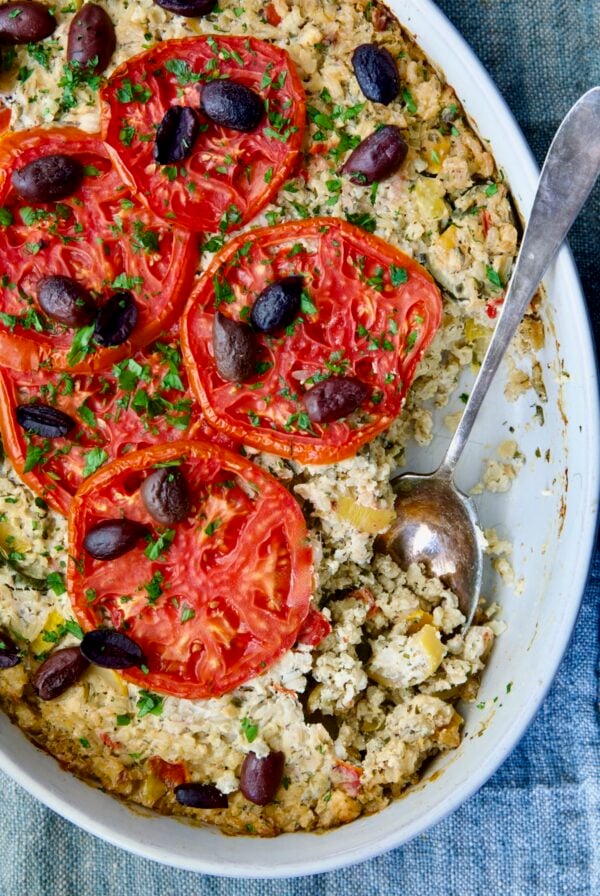 Greek Vegetable Casserole Recipe in oval baking dish with serving spoon.