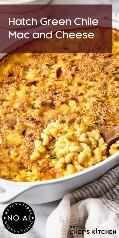 Pinterest graphic for Hatch Green Chile Mac and Cheese showing it in a white baking dish with a wooden spoon scooping some up.