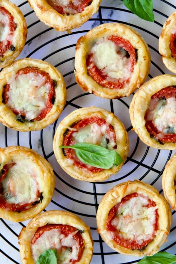 Mini Southern Tomato Pies on round black wire cooling rack.