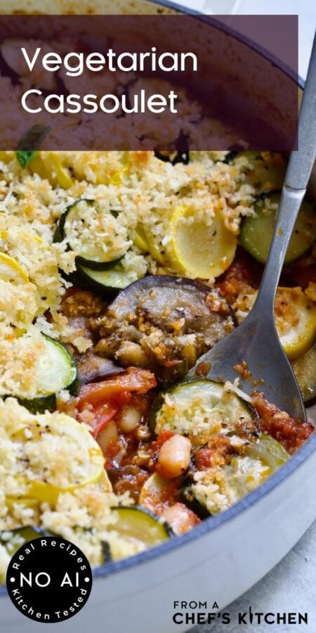 Pinterest graphic for Vegetarian Cassoulet showing it in a white enamel cast iron skillet with serving spoon.