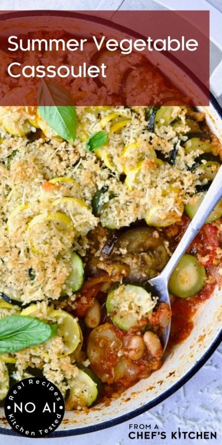 Pinterest graphic for Vegetarian Cassoulet showing it in a white enamel cast iron skillet with serving spoon.