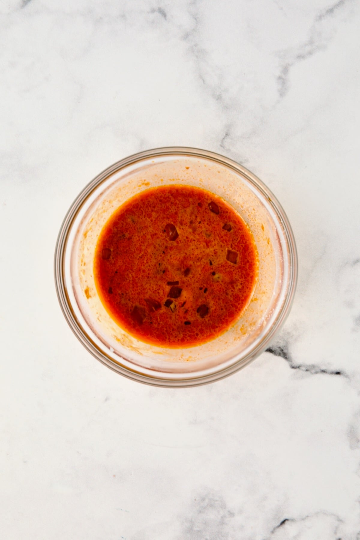 Sauce in glass bowl with corn starch added.