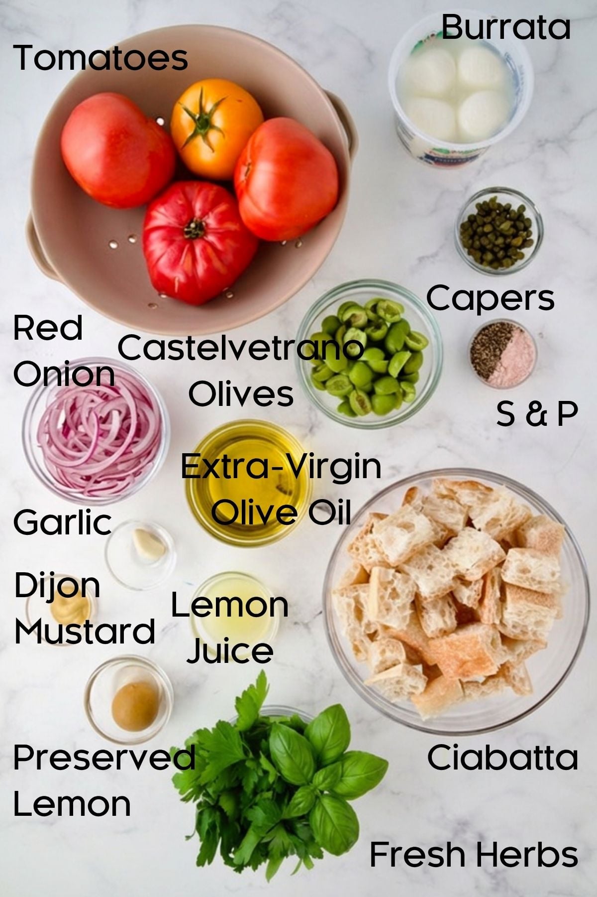 Ingredients for Panzanella with Preserved Lemon Vinaigrette in glass bowls.