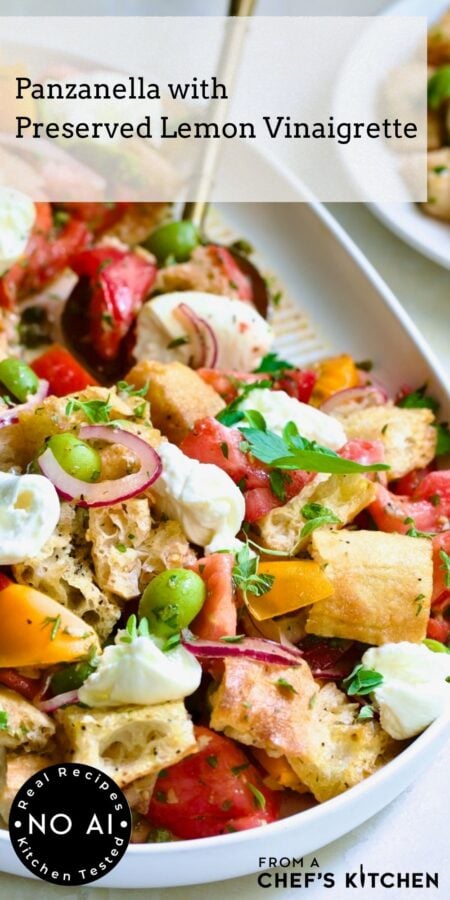 Pinterest graphic for Panzanella with Preserved Lemon Vinaigrette showing it on a white oval platter with gold serving utensil.