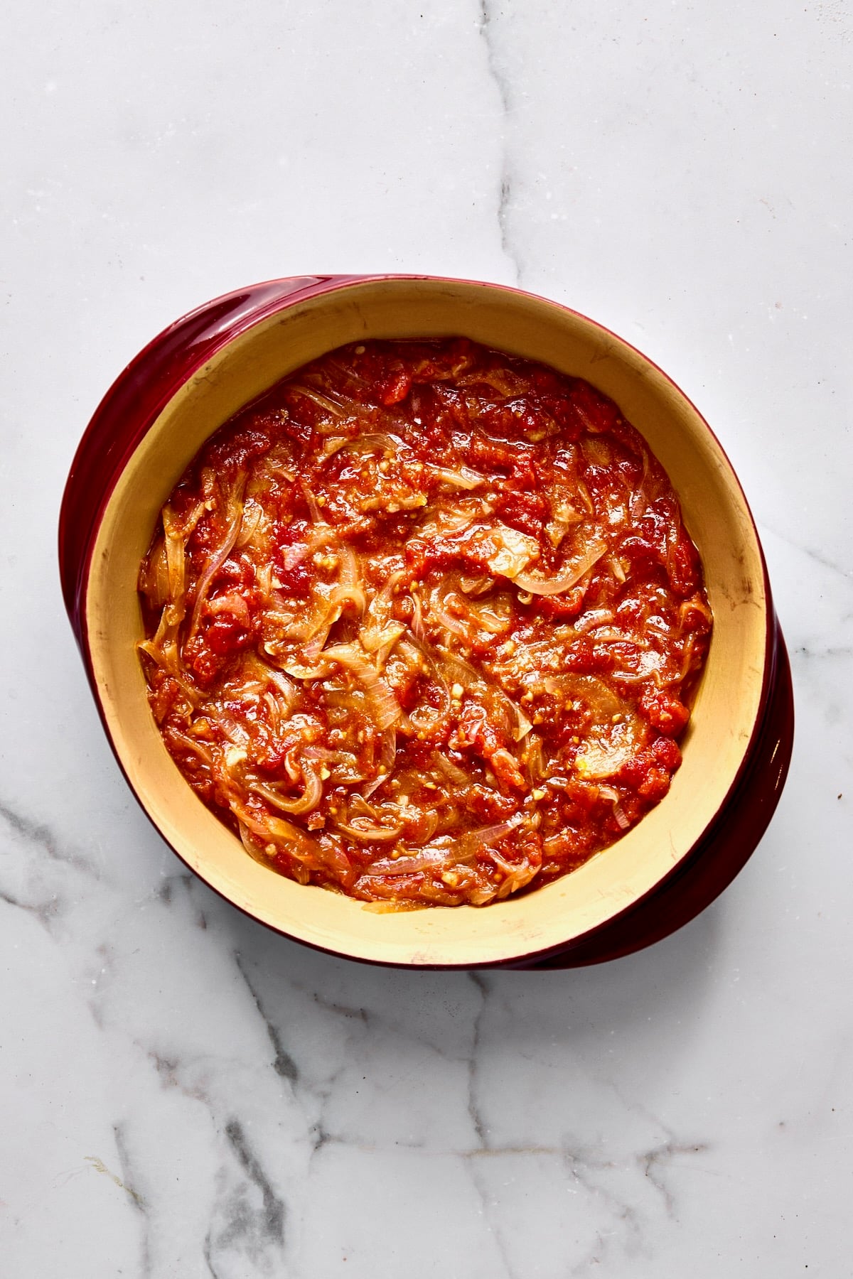 Tomato sauce in round baking dish.