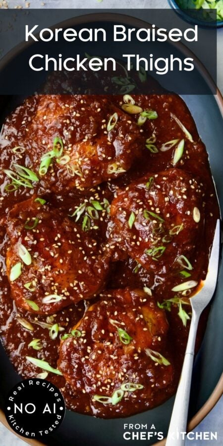 Pinterest graphic for Korean Braised Chicken Thighs showing them on an oval black platter with meat fork.