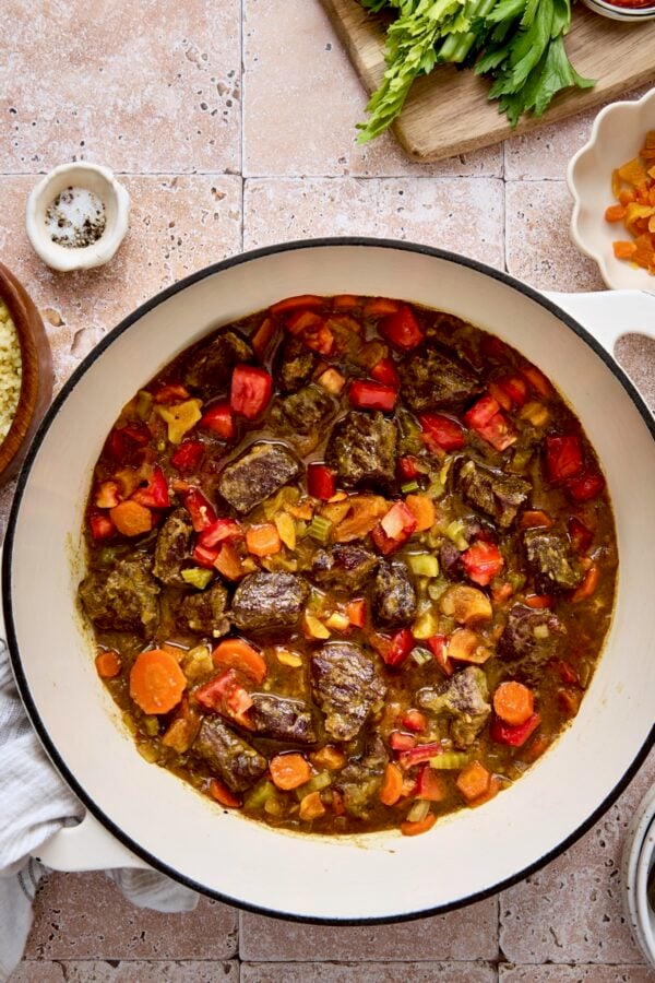 Moroccan Beef Stew in white enamel Dutch oven.
